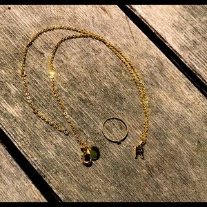 Gold necklace of letter “R”, and gold ring with small jewel.